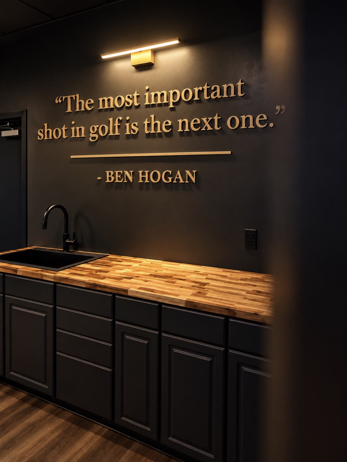 Gold Ben Hogan quote on the club wall — The most important shot in golf is the next one — above a butcher-block counter